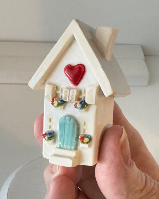 White clay House with aqua mint colored door